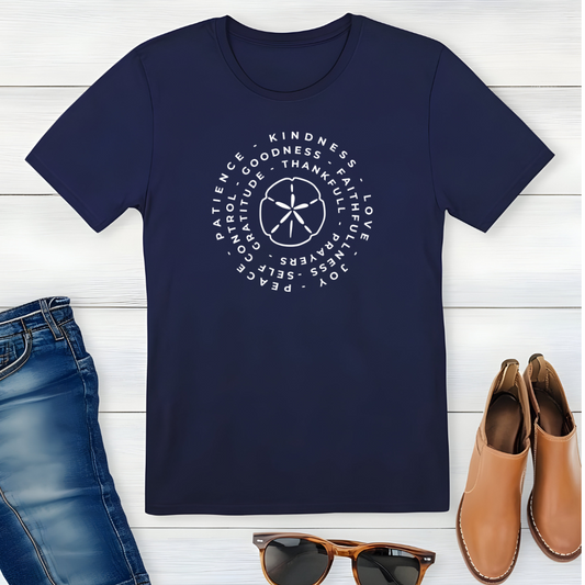 Navy blue t-shirt with white text and graphics on a wooden surface with jeans, sunglasses, and shoes.