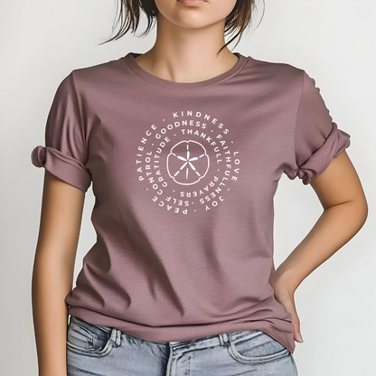 Person wearing a mauve t-shirt with white text design on a plain background