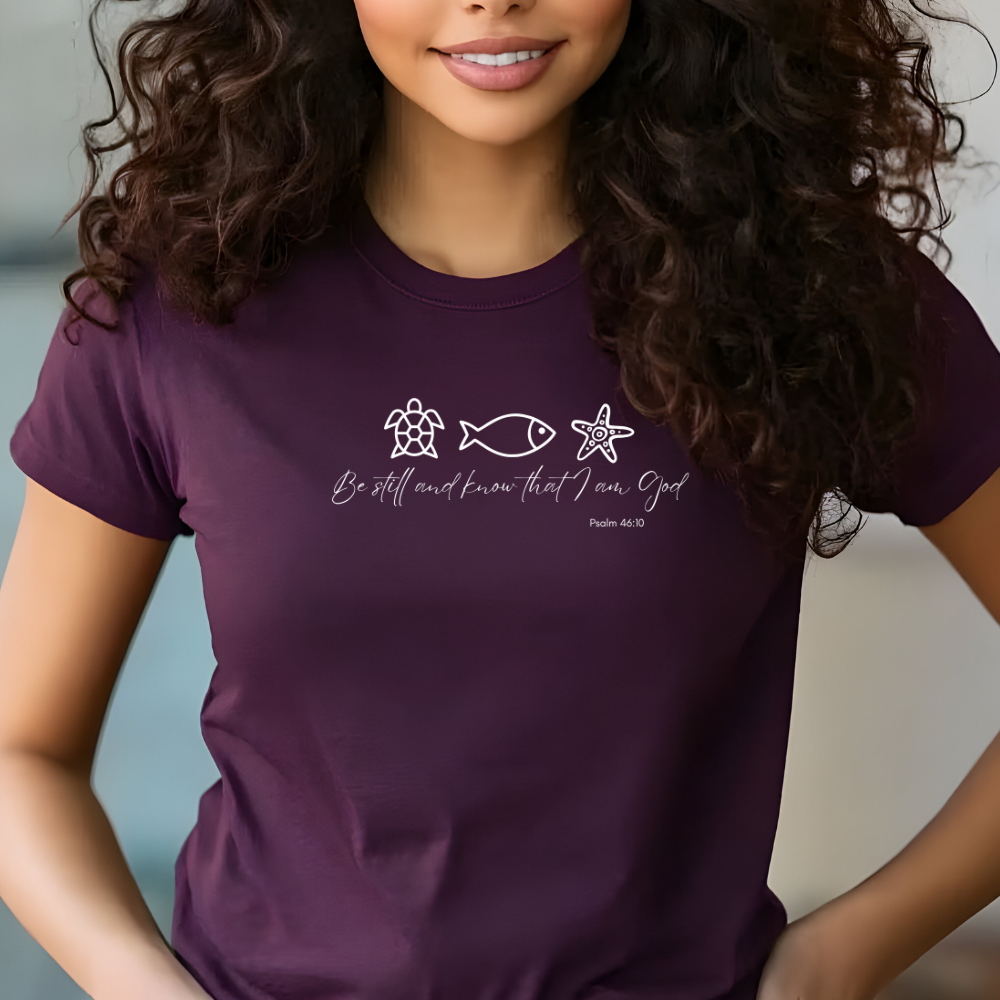 Woman wearing a purple t-shirt with a design and text.
