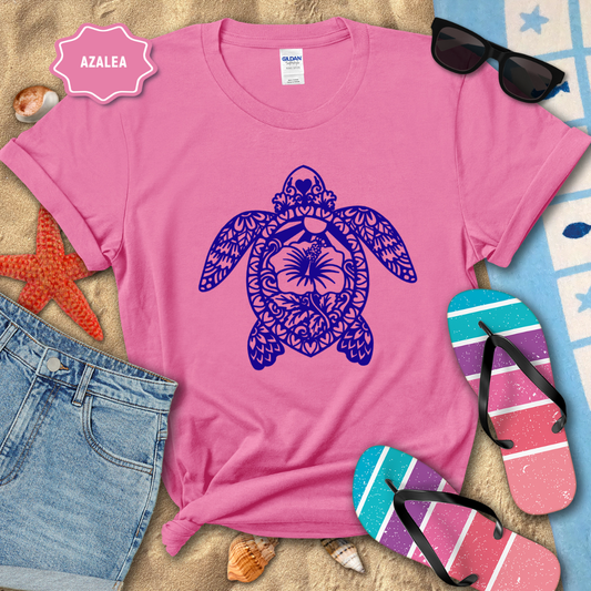 Pink t-shirt with a purple turtle design on a beach-themed background
