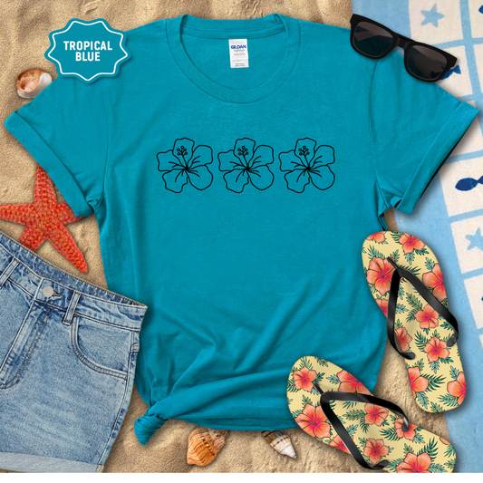 Blue t-shirt with floral designs, sunglasses, and flip-flops on a beach-themed background