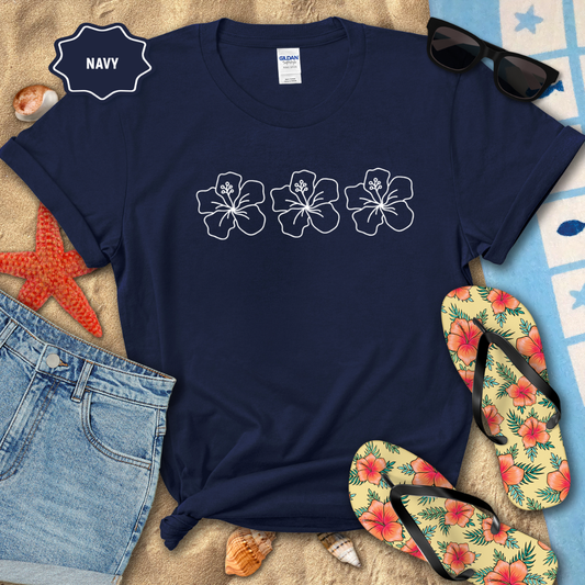 Navy t-shirt with floral designs on a beach-themed background with flip-flops and sunglasses.
