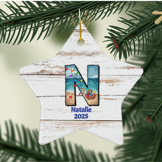 Star-shaped Christmas ornament with 'N' and 'Natalie 2025' text, hanging on a tree.