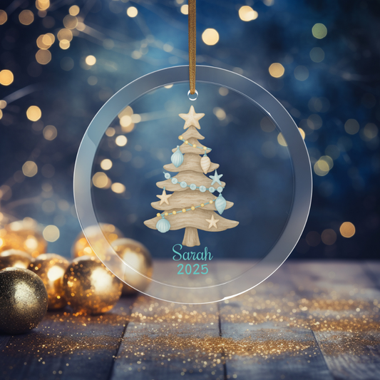 Decorative Christmas tree ornament with 'Sarah 2025' text, surrounded by festive lights and ornaments.