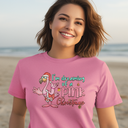 Woman wearing a pink t-shirt with a flamingo graphic and text on a beach.