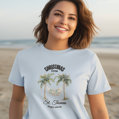 Woman wearing a light blue t-shirt with 'Christmas Crew St. Thomas Virgin Islands' design on a beach.