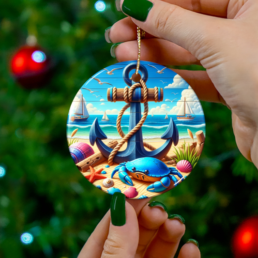 Decorative ornament with an anchor and beach scene held by a hand against a Christmas tree.
