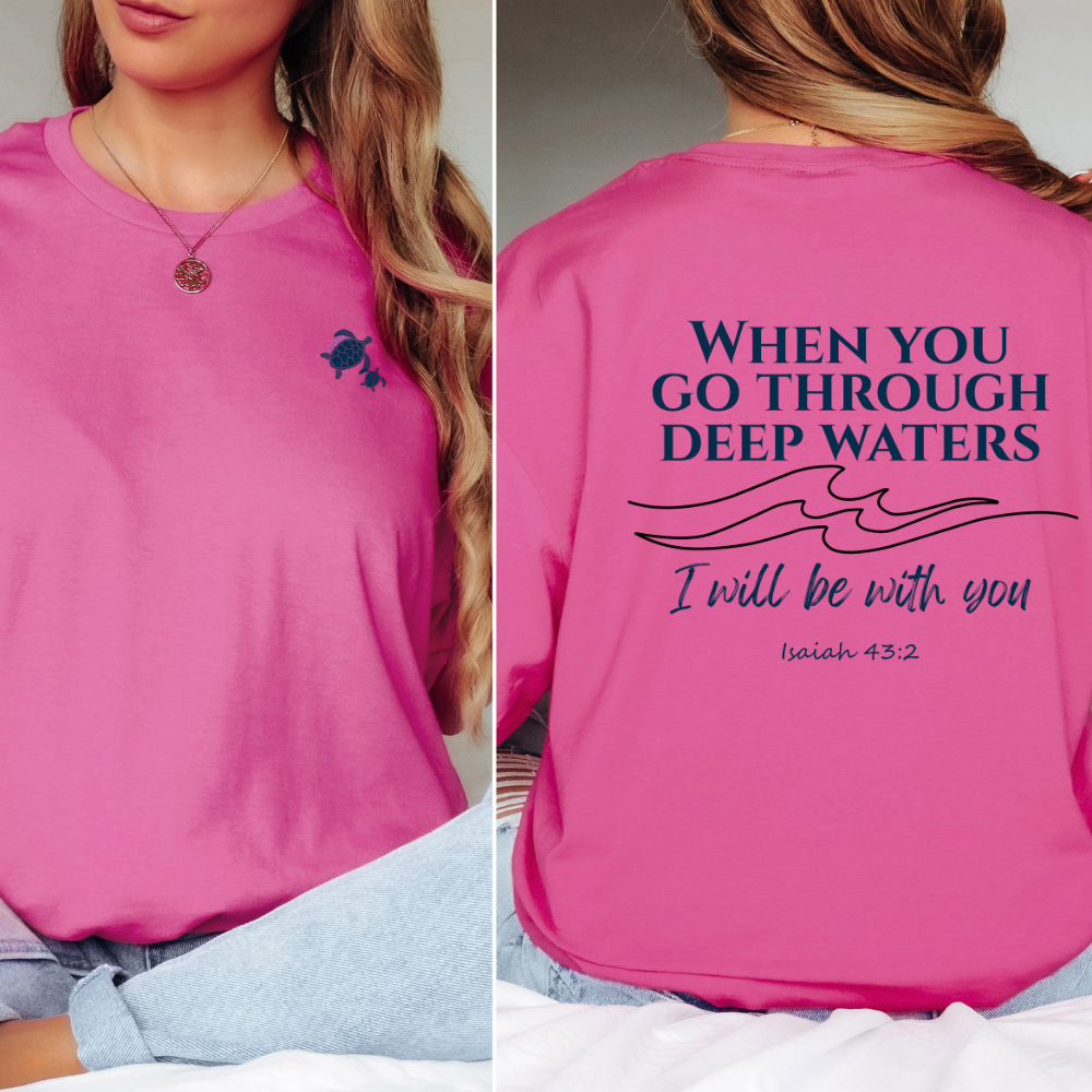 Pink shirt with a small turtle design on the front and motivational quote on the back.
