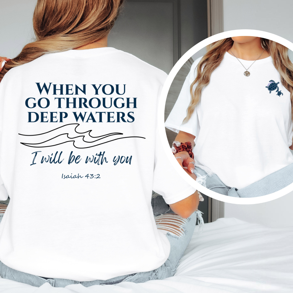 White t-shirt with motivational quote and wave design, worn by a person.