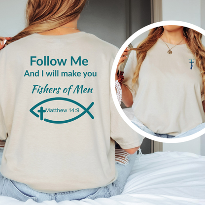 Person wearing a beige t-shirt with a religious message and fish symbol, sitting on a bed.