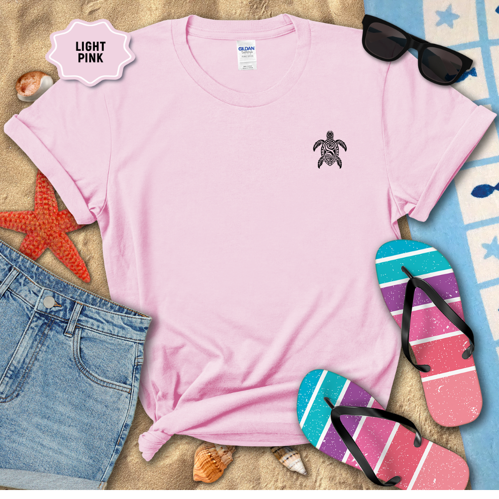 Light pink t-shirt with a turtle design, sunglasses, denim shorts, and flip-flops on a beach-themed background.
