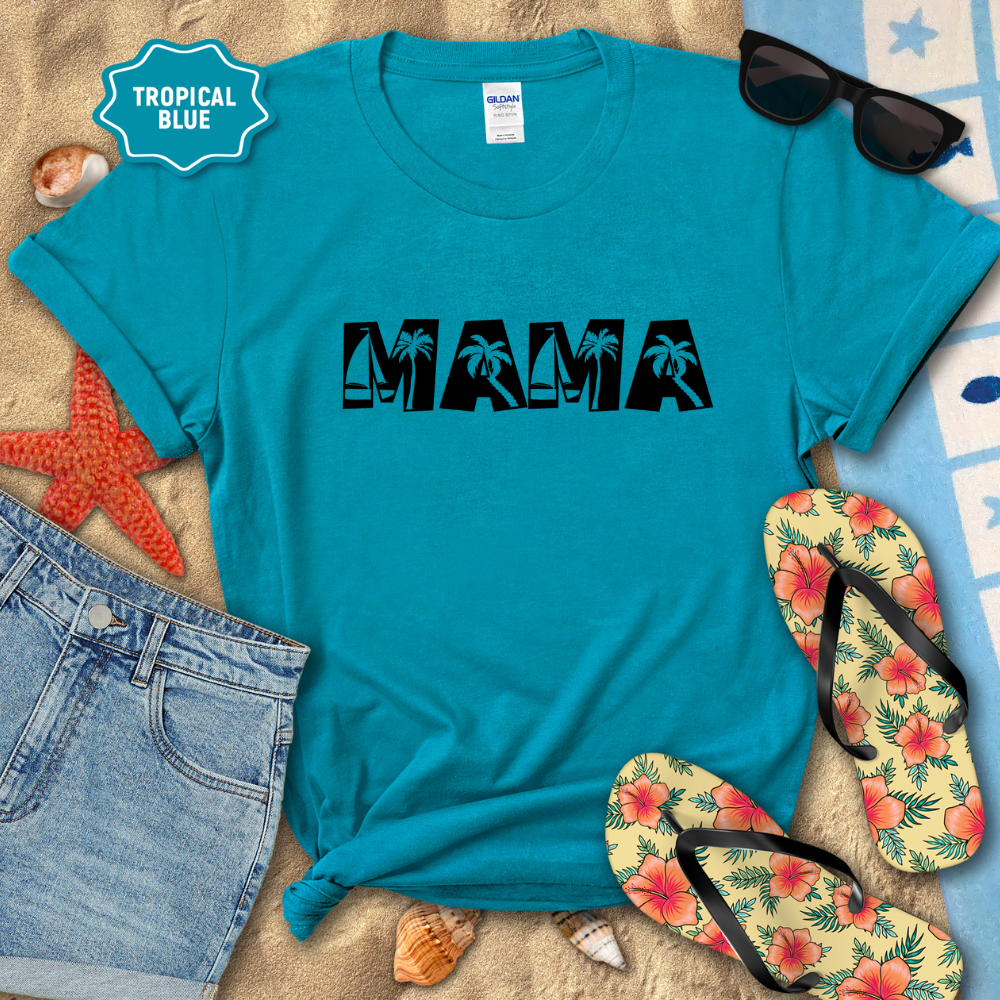 Turquoise t-shirt with 'MAMA' print on a sandy surface with sunglasses, flip-flops, and denim shorts.