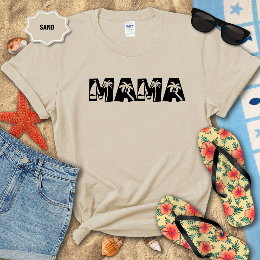Beige t-shirt with 'MAMA' text, sunglasses, flip-flops, and beach accessories on a sandy background