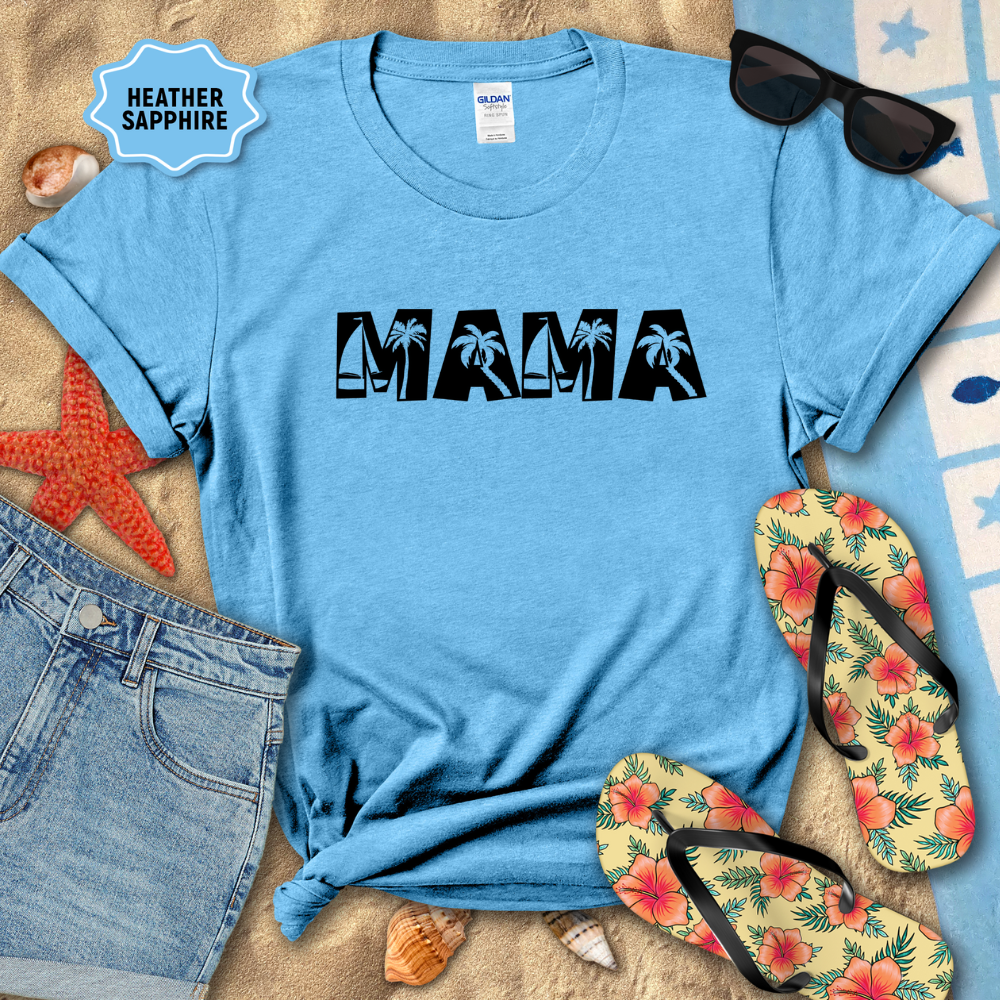Blue t-shirt with 'MAMA' text, sunglasses, flip-flops, and denim shorts on a sandy surface.
