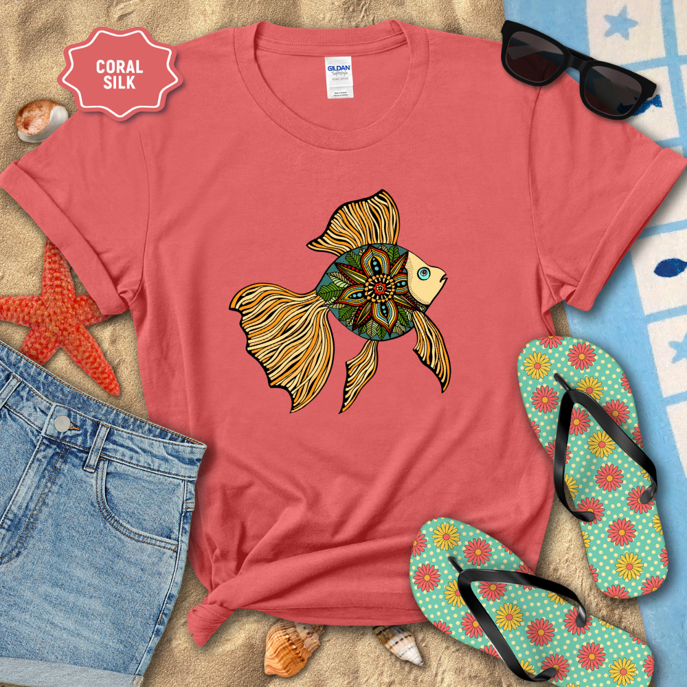 Red t-shirt with a fish design, sunglasses, and flip-flops on a beach setting.