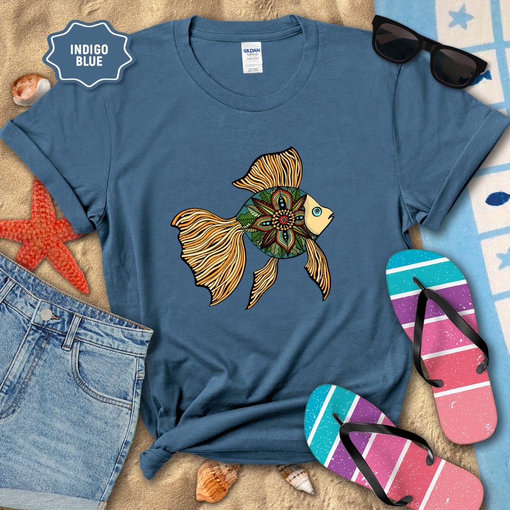 Indigo blue t-shirt with a colorful fish design, sunglasses, and flip-flops on a beach setting.
