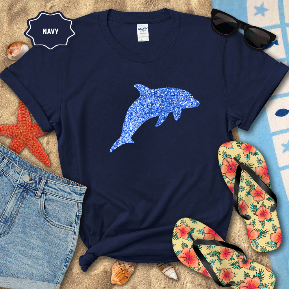 Navy t-shirt with blue dolphin design on a beach-themed background with flip-flops and sunglasses.