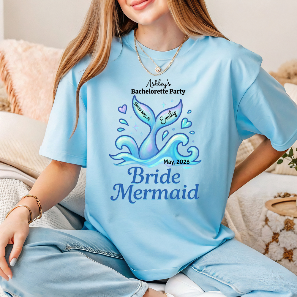 Person wearing a light blue t-shirt with 'Bride Mermaid' design and text.