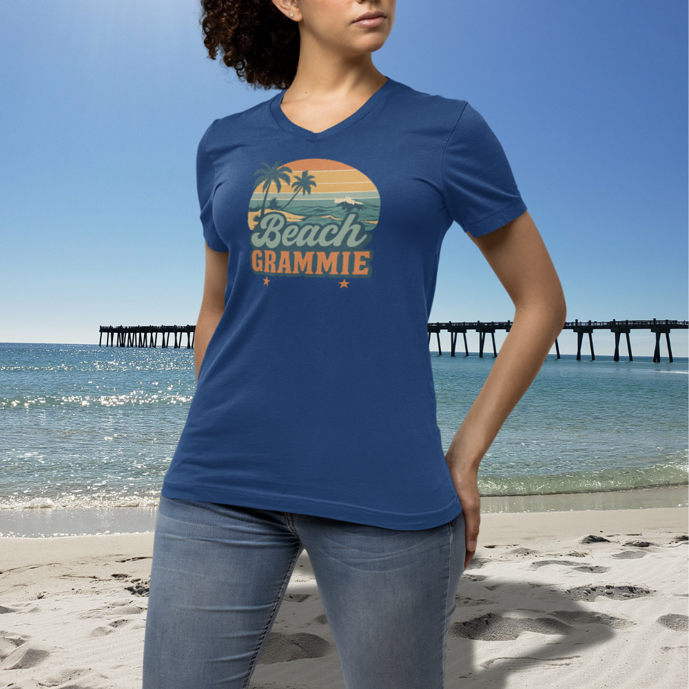 Woman wearing a blue t-shirt with 'Beach Grammie' design on a beach.