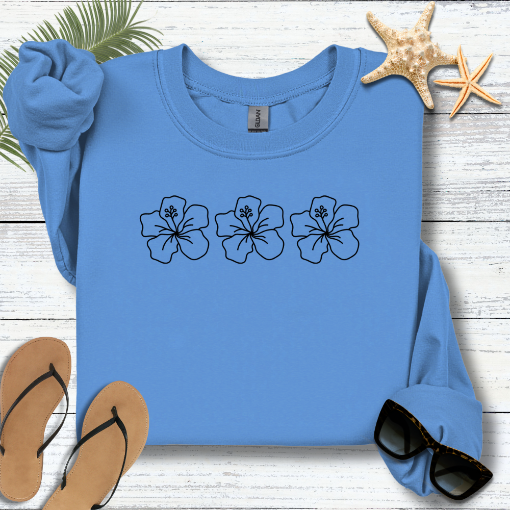Blue sweatshirt with floral designs on a wooden surface with flip-flops and a starfish.