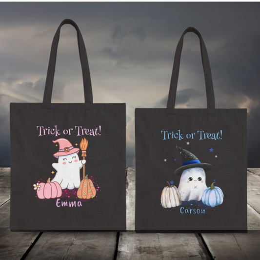 Two Halloween-themed tote bags with ghost illustrations and 'Trick or Treat!' text on a wooden surface with a cloudy sky background.