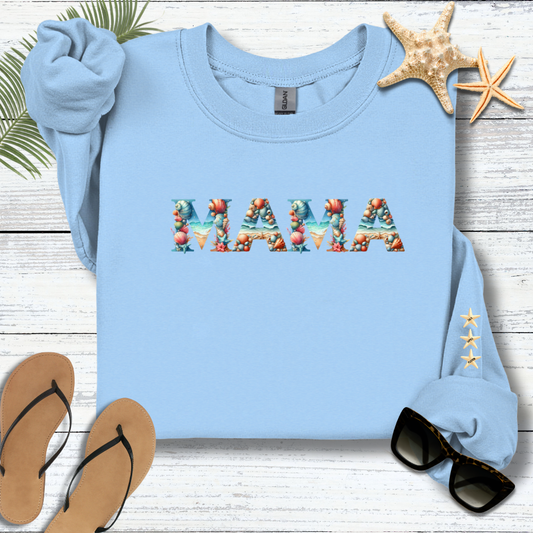 Light blue sweatshirt with 'MAMA' printed on it, surrounded by flip-flops, sunglasses, and starfish on a wooden surface.