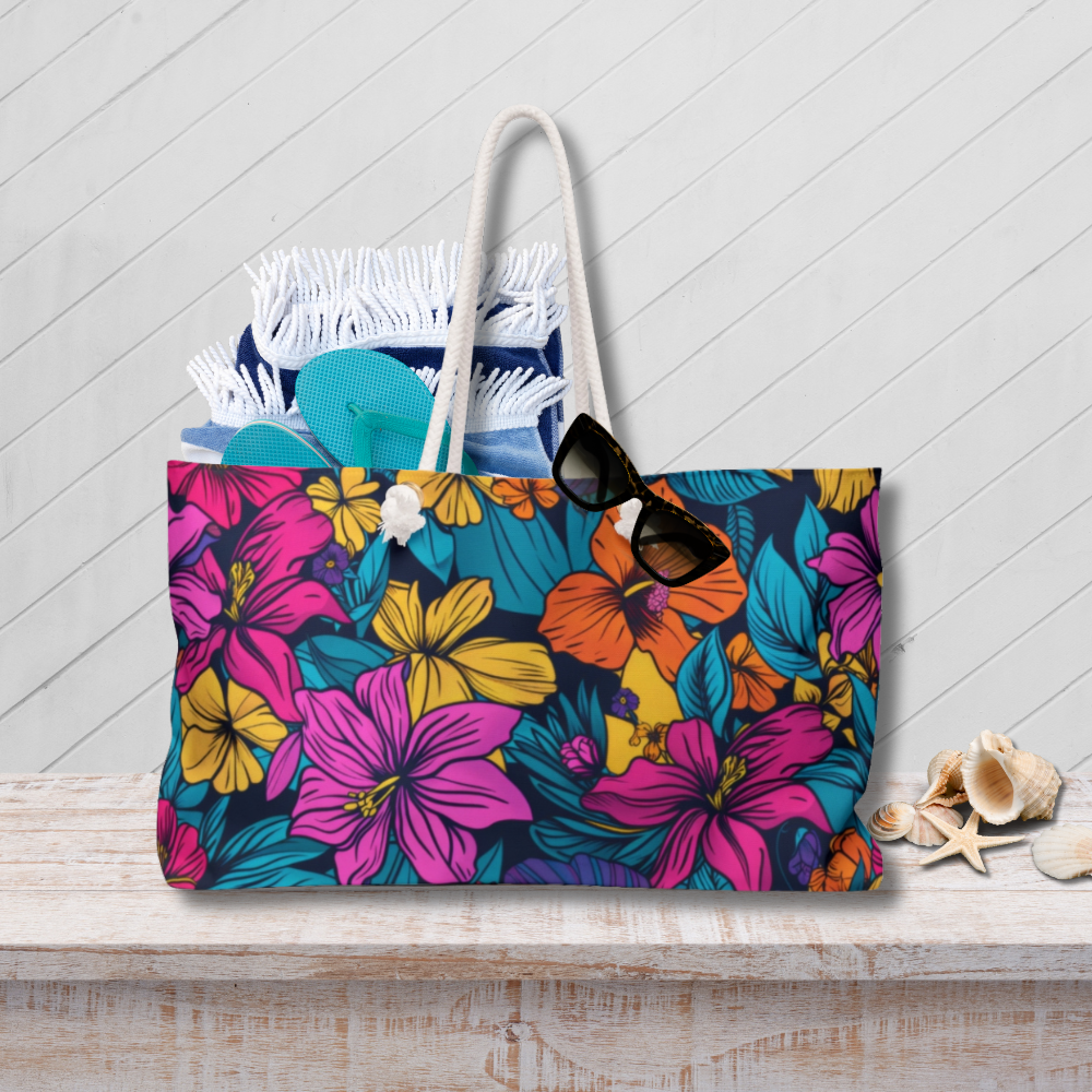 Floral tote bag with sunglasses and flip-flops on a wooden surface