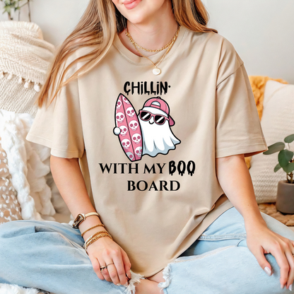 Person wearing a beige t-shirt with a graphic design and text.
