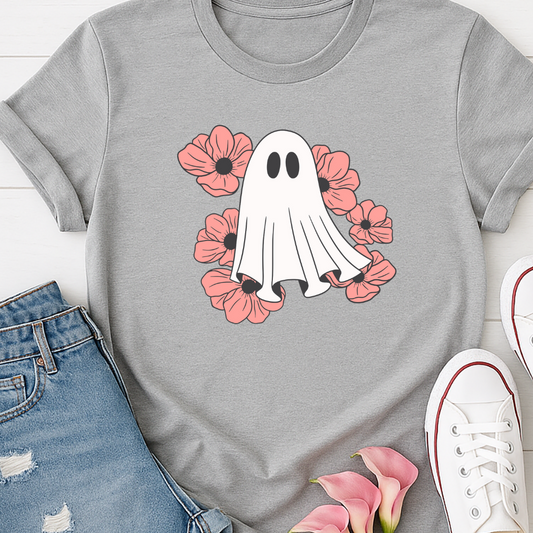 Gray t-shirt with a ghost and flowers design, paired with jeans and sneakers on a light wooden surface.
