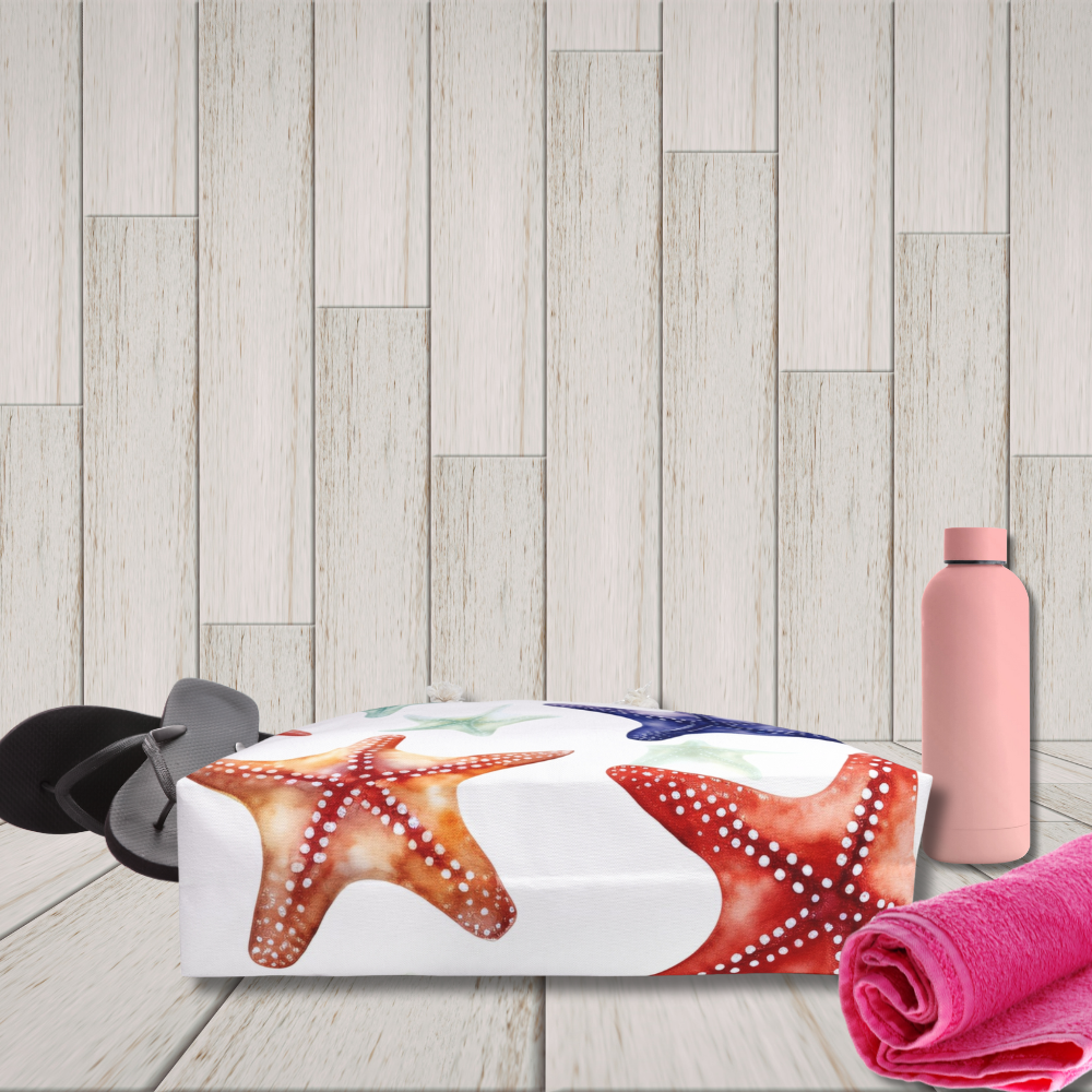 Starfish-themed beach bag with pink water bottle and towel on wooden floor