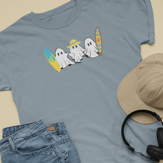 Blue t-shirt with ghost design, beige hat, blue jeans, and black headphones on a beige background