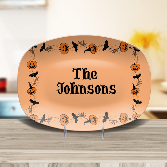 Halloween-themed platter with decorative border and 'The Johnsons' text on a wooden surface.