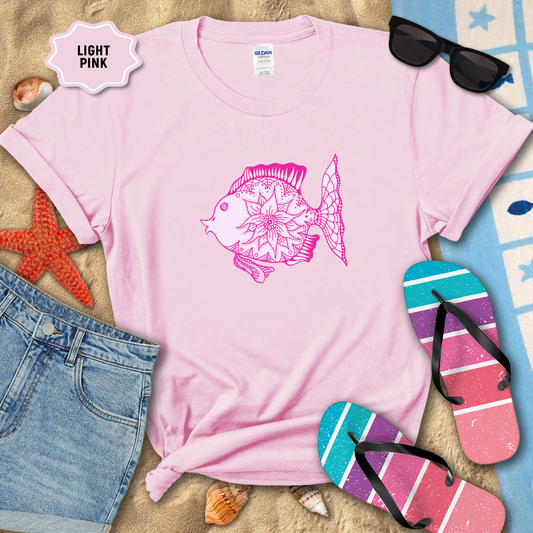 Light pink t-shirt with a fish design, sunglasses, and flip-flops on a sandy background