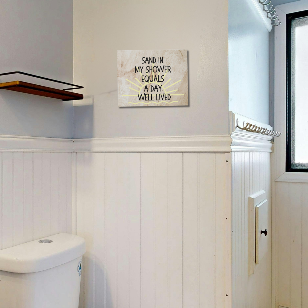 Bathroom with a toilet and motivational sign on the wall.