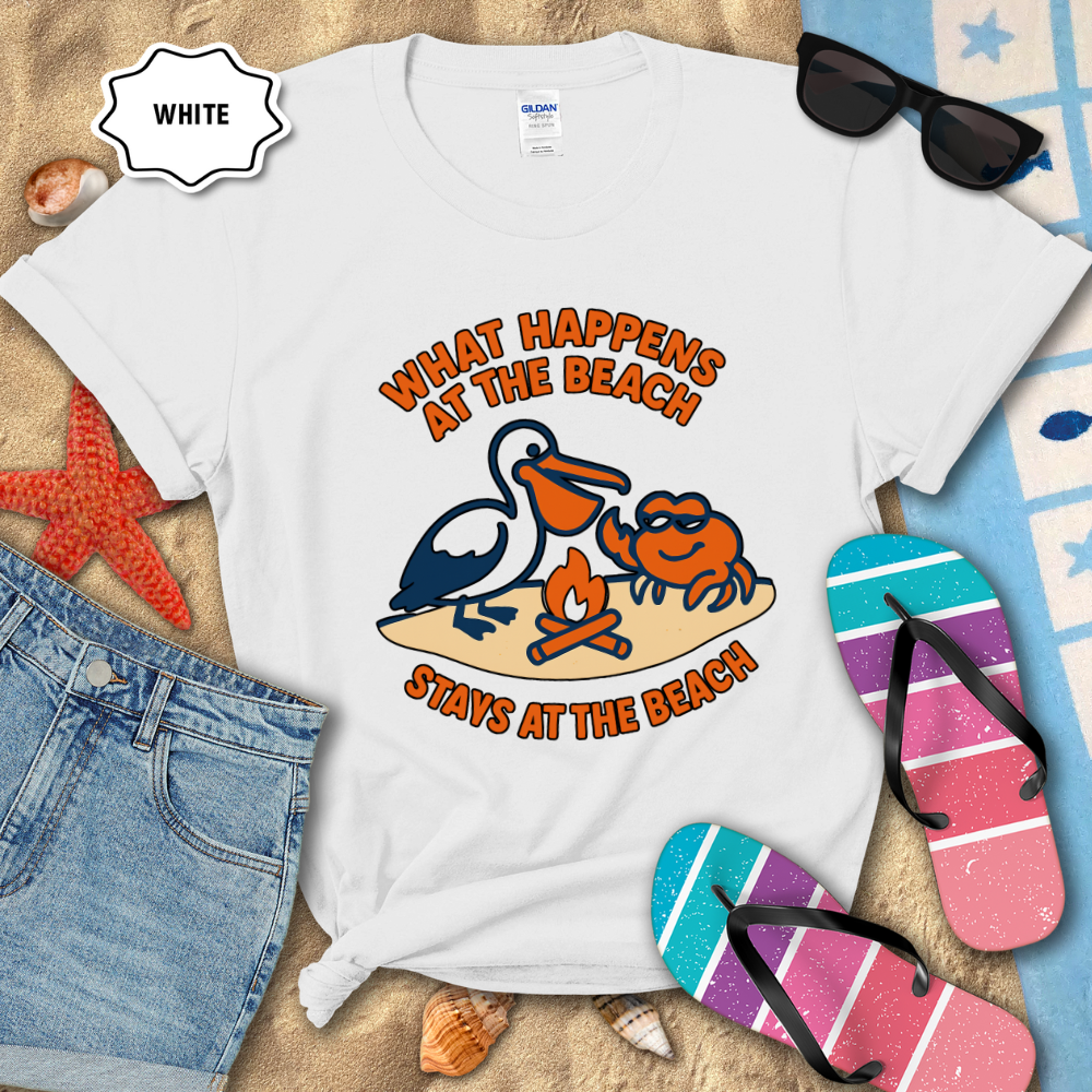 White t-shirt with beach-themed design and accessories on sand