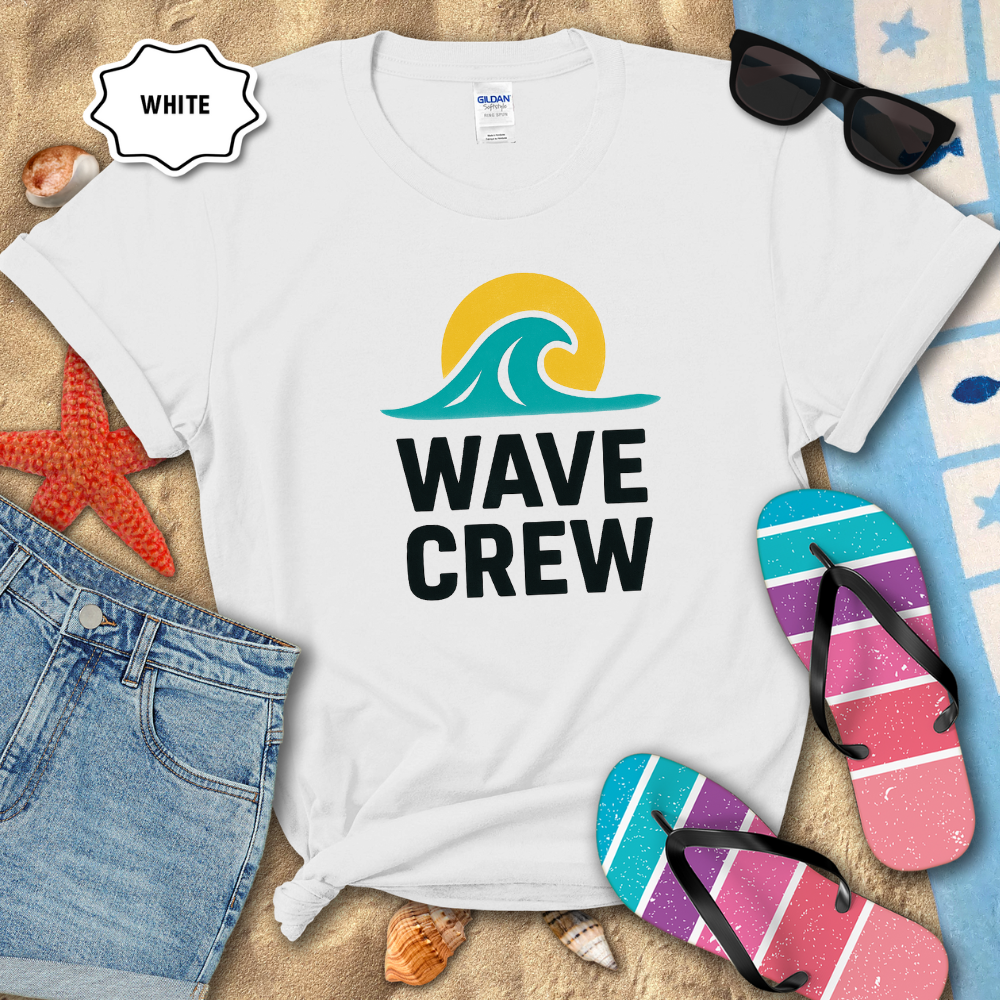 White t-shirt with 'Wave Crew' design on a sandy background with beach accessories.