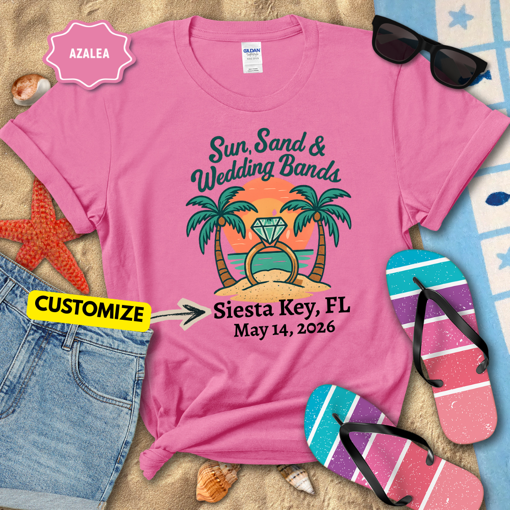 Pink t-shirt with 'Sun, Sand & Wedding Bands' design on a beach-themed background