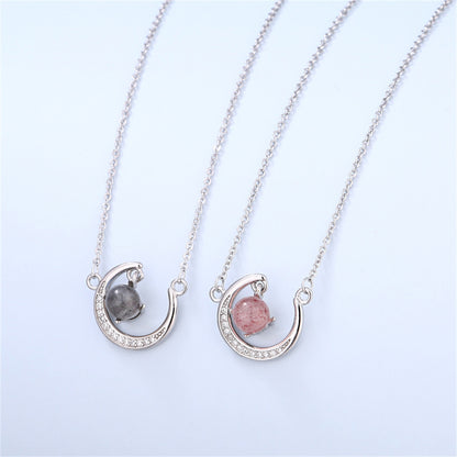 Romantic daughter jewelry gift featuring a silver crescent moon pendant and pink or blue crystal in a keepsake box with loving message.