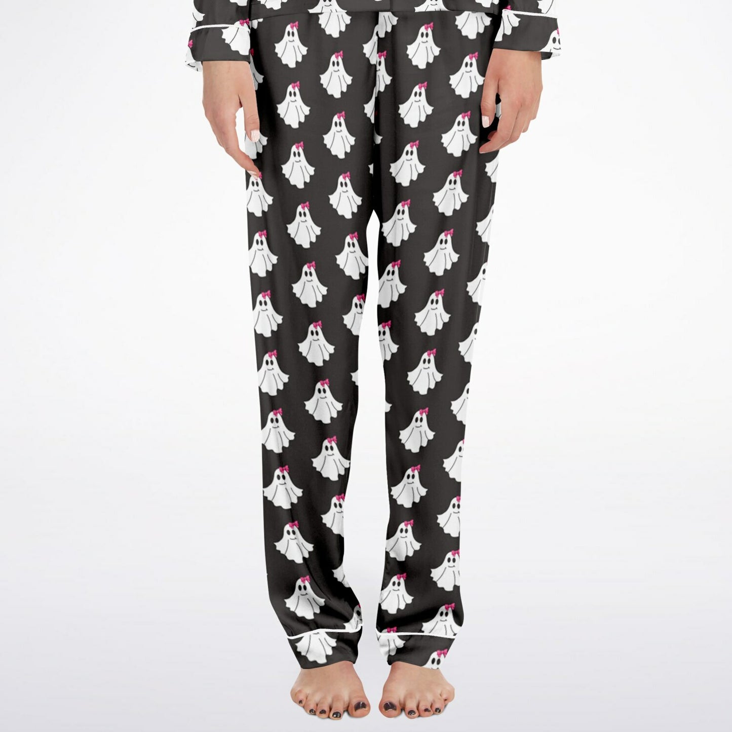 Black pajama pants with ghost pattern worn by a person on a white background