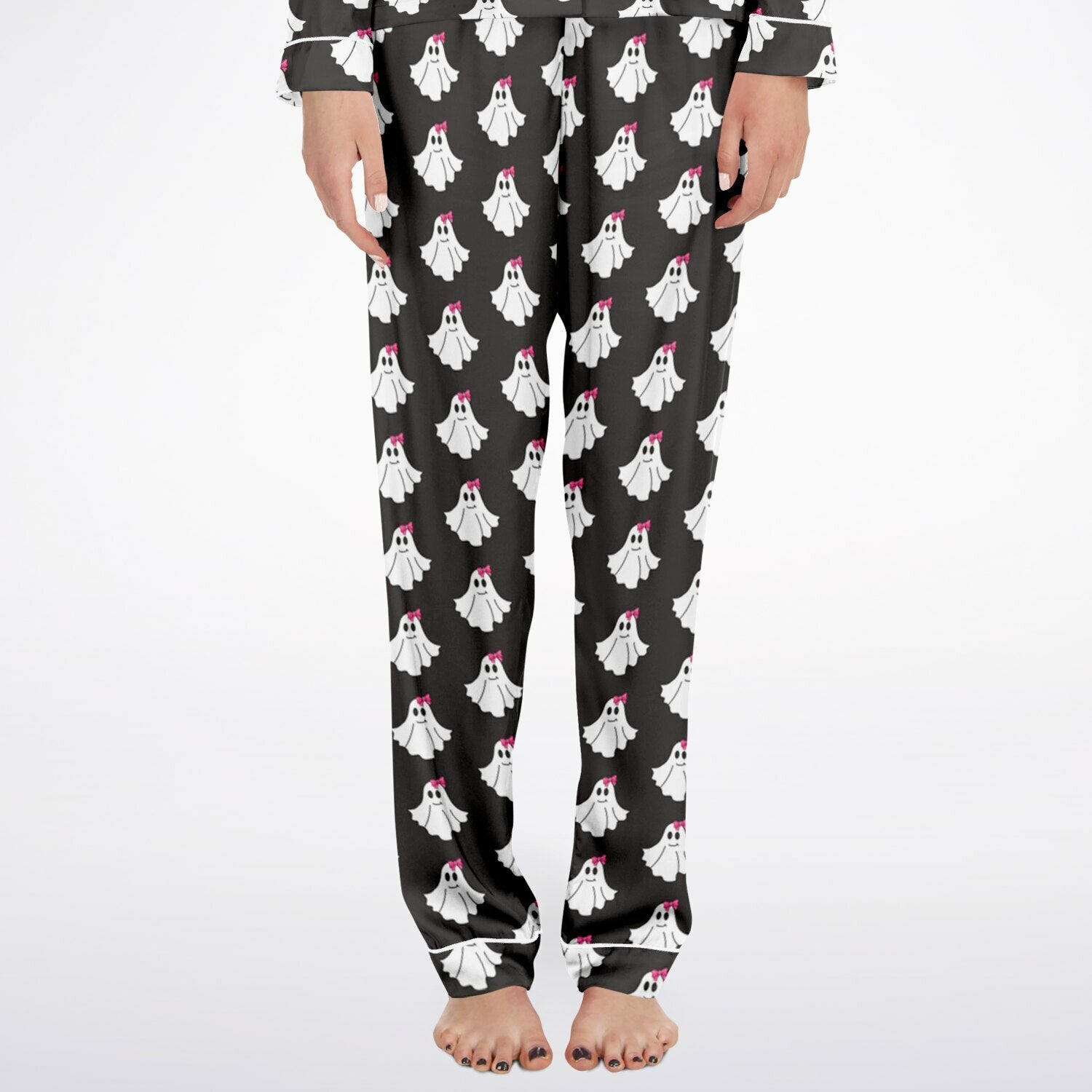 Black pajama pants with ghost pattern worn by a person on a white background