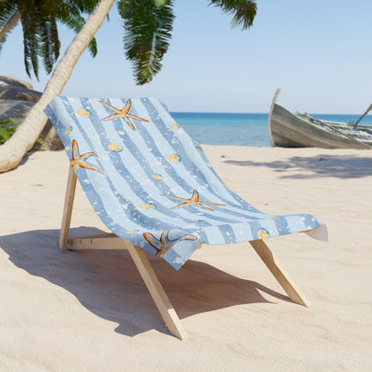 Pink beach towel with scattered palm tree design on a lounge chair