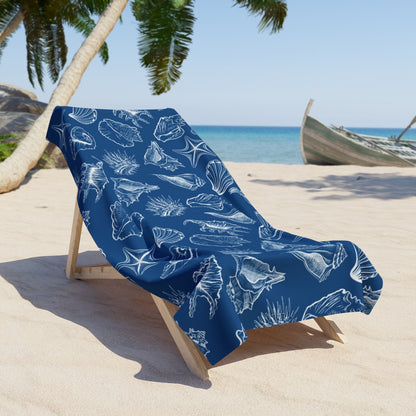 Fish-themed beach towel with soft cotton backing by the ocean