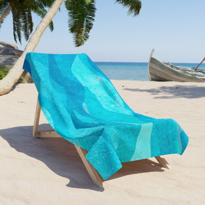 Vibrant blue wave pattern beach towel laid flat