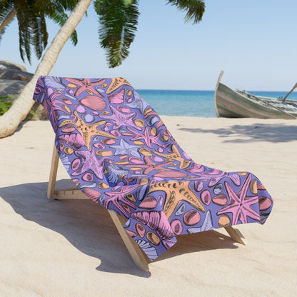 Beach towel with colorful seashell and starfish pattern on purple