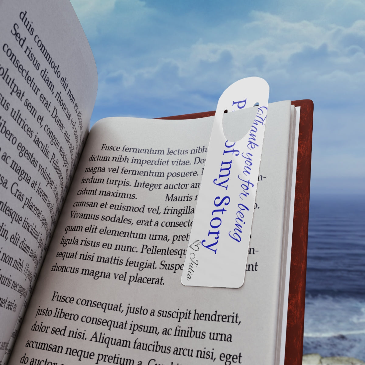 Bookmark gift idea placed inside an open book near the ocean
