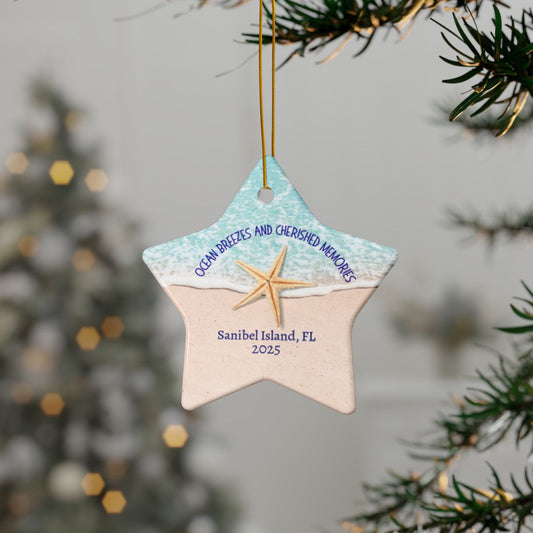Star-shaped ornament with beach design and text, hanging on a tree.