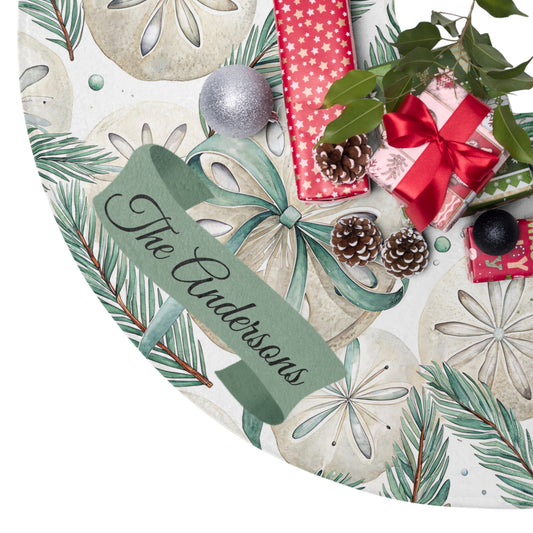 Personalized Christmas plate with green ribbon, pine cones, and gift boxes on a decorative background.