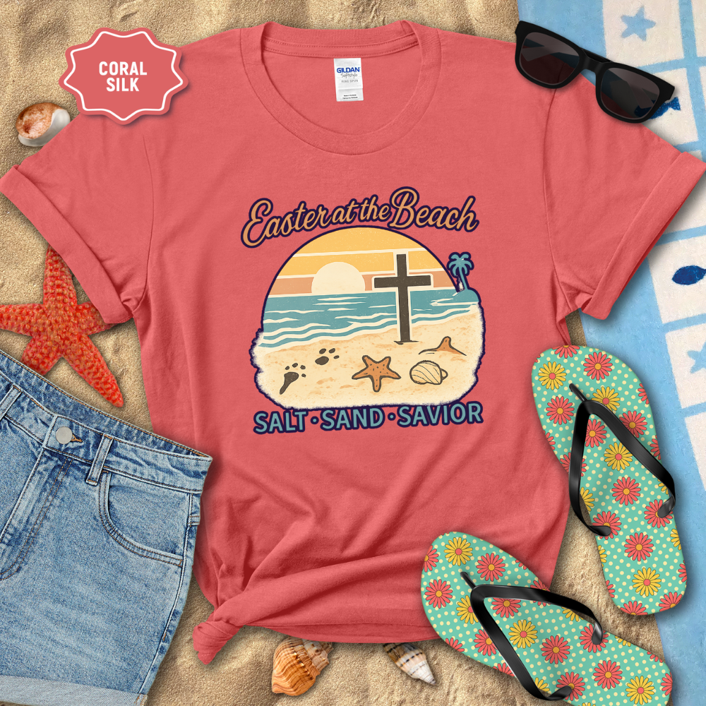 Red t-shirt with 'Easter at the Beach' design on a sandy background with flip-flops and sunglasses.
