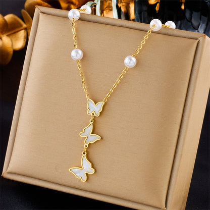 Close-up of nature-inspired 18K gold necklaces with gold chain and delicate butterflies

