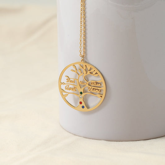 Gold tree-shaped pendant necklace with engraved text on a white background